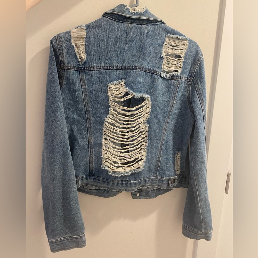 Cute jean jacket. Denim. With rips for style.